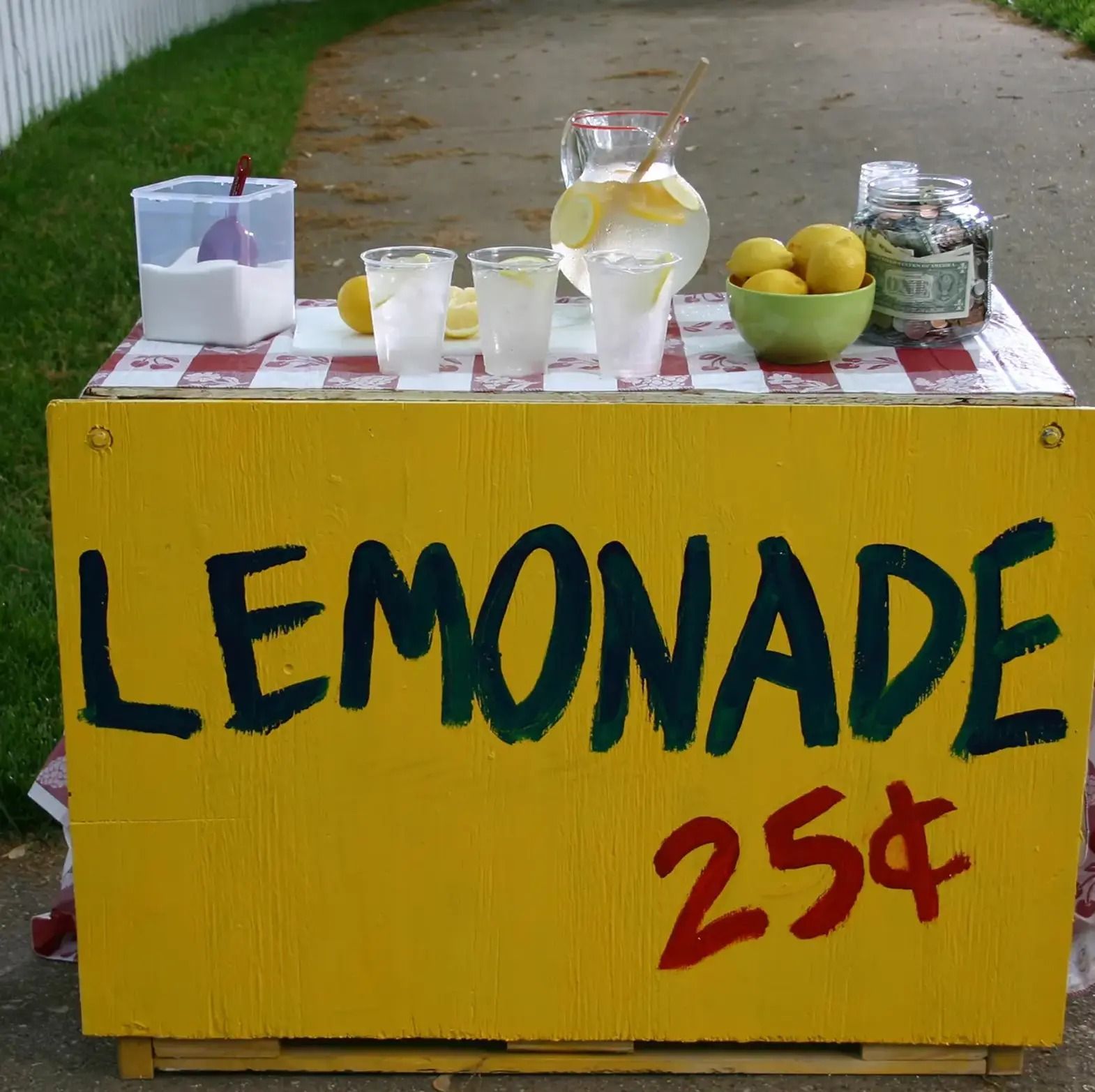 A lemonade stand with a sign that says lemonade 25 cents