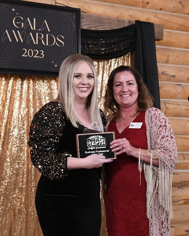 Two women are standing next to each other in front of a sign that says gala awards 2023.