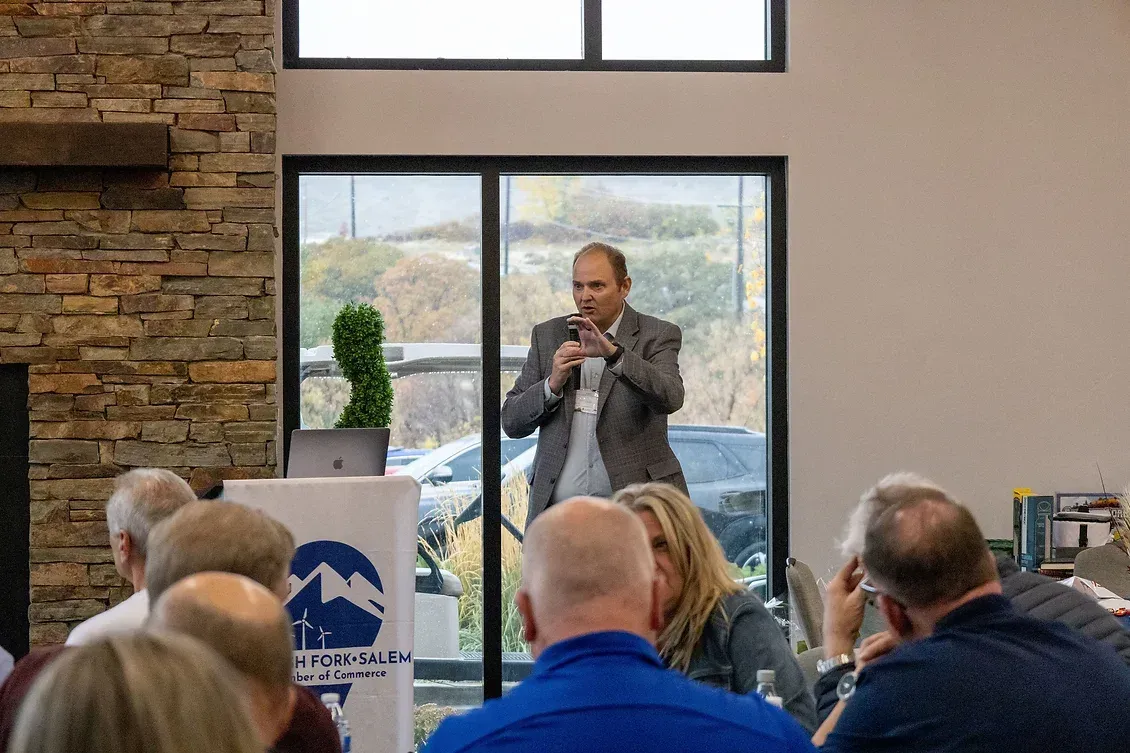 A man is giving a presentation to a group of people in a room.