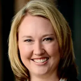 A close up of a woman 's face smiling.