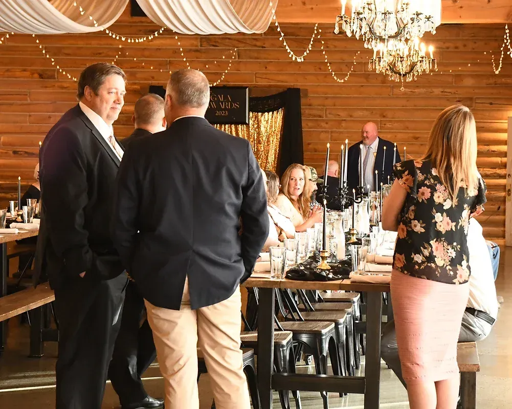 A group of people are standing around a table in a room.