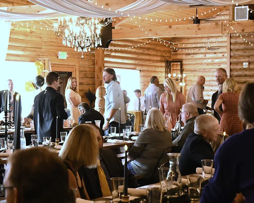 A large group of people are sitting at tables in a restaurant.
