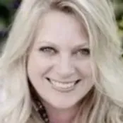 A close up of a woman 's face smiling.