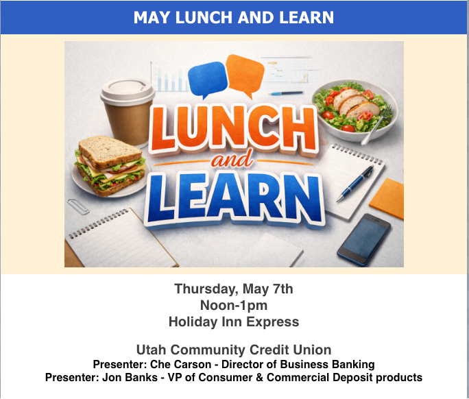 A man in a suit and plaid shirt is smiling for the camera.