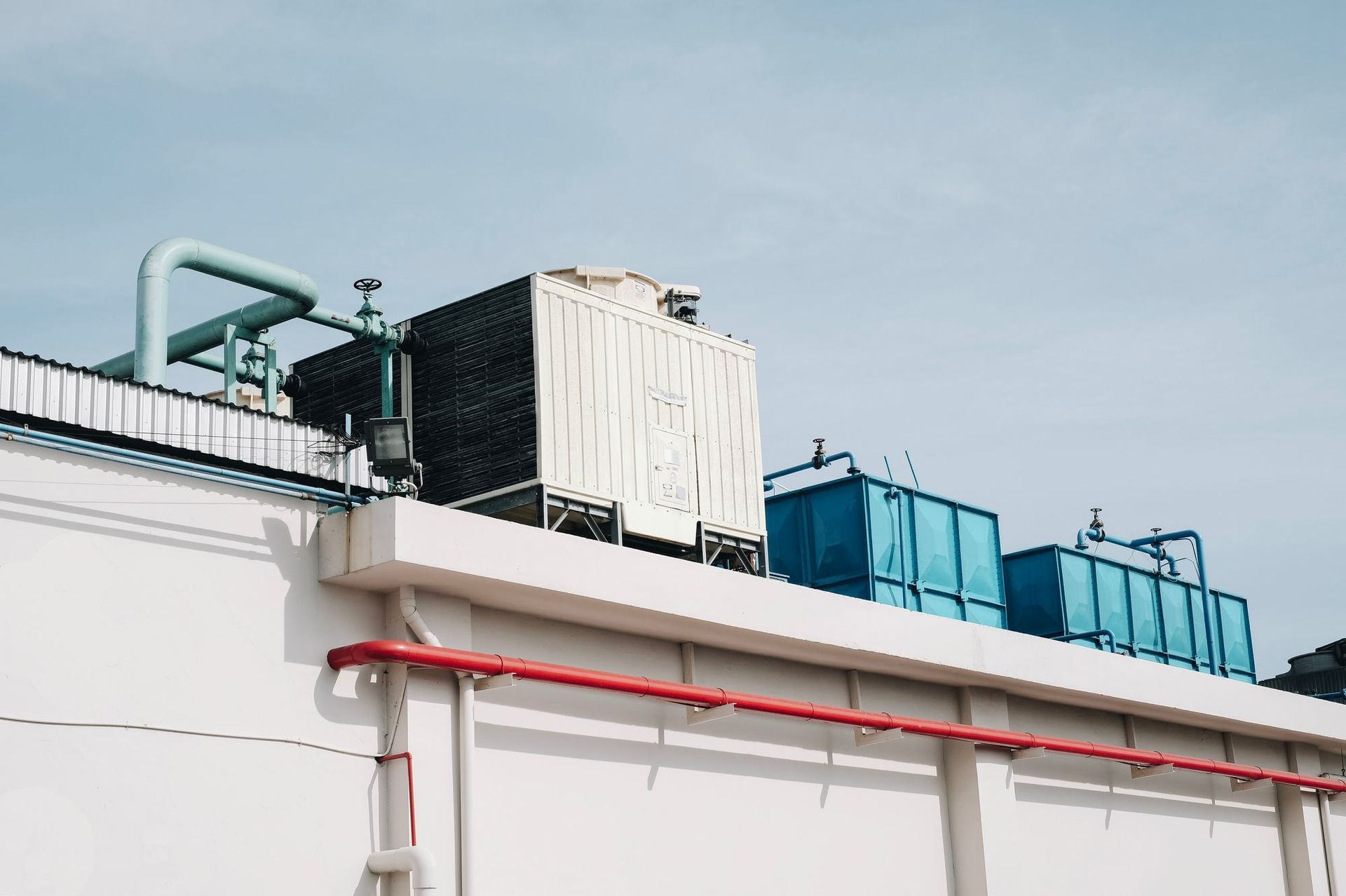 There are a lot of pipes on the roof of a building.