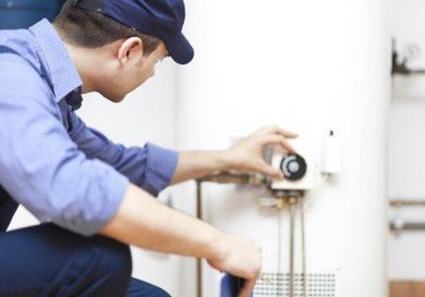 Plumber Repairing Water Heater — Sewer Repair in Oro Valley, AZ