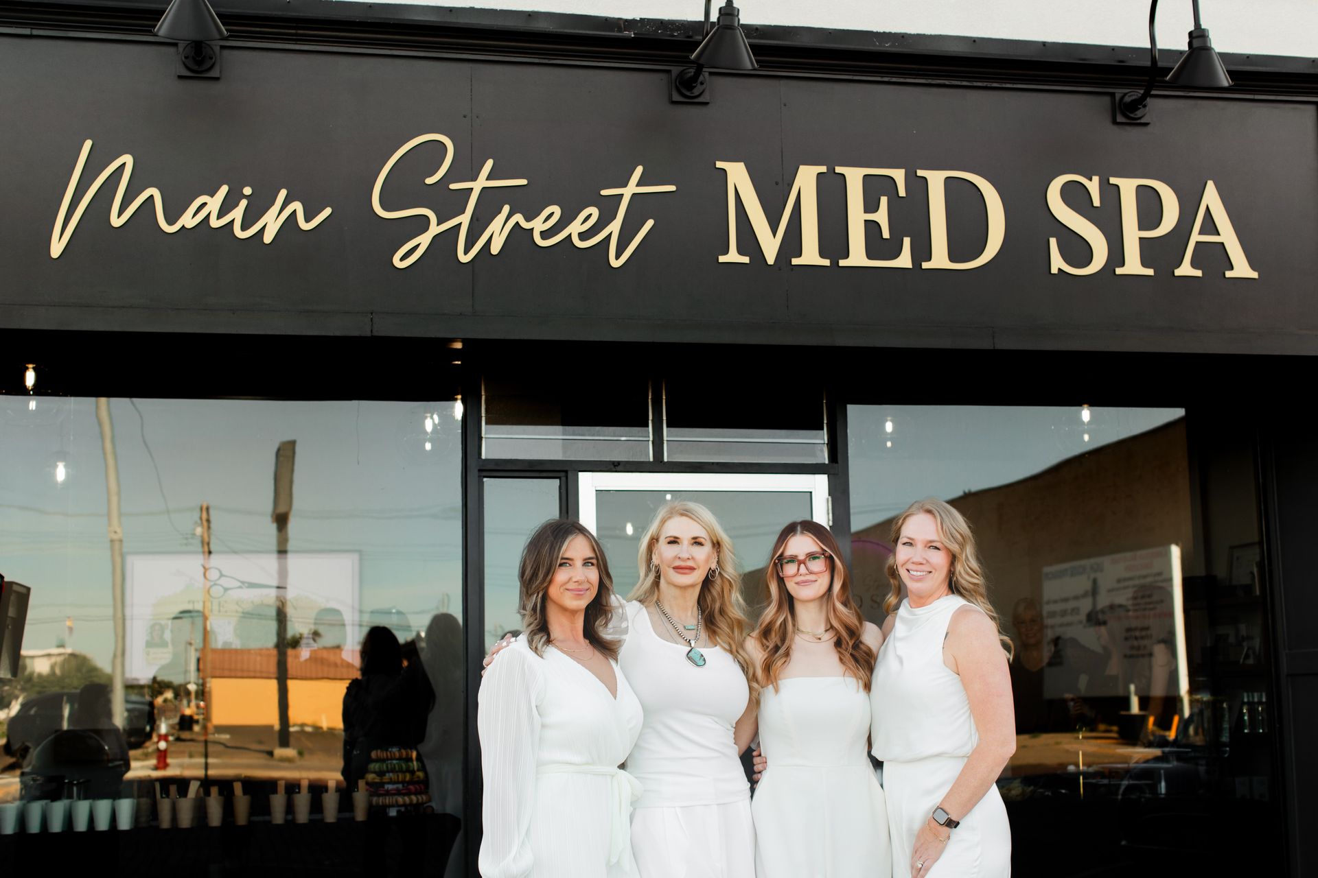 Four women standing together during the construction of Main Street Med Spa in Clovis, NM.