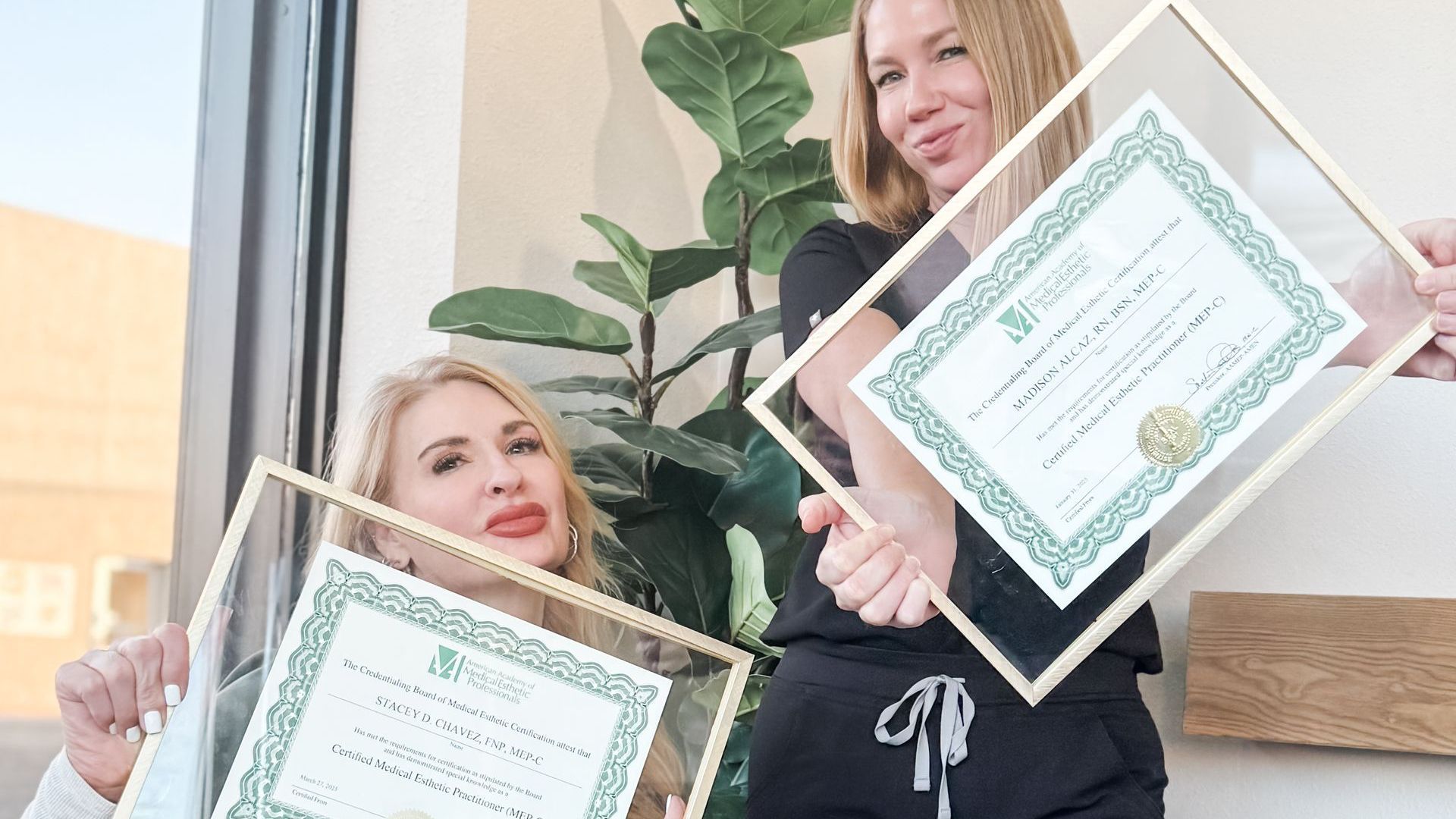 Madison and Stacey holding their MEP-C certifications at Main Street Med Spa in Clovis, NM—demonstrating advanced training in medical aesthetics.