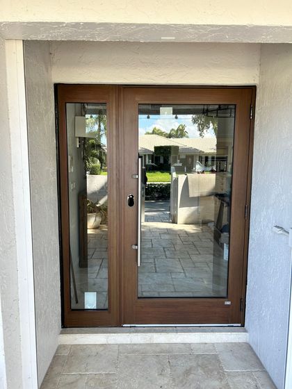A wooden door with a lot of glass on it