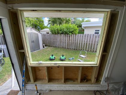 A window is being built into a wall in a house.