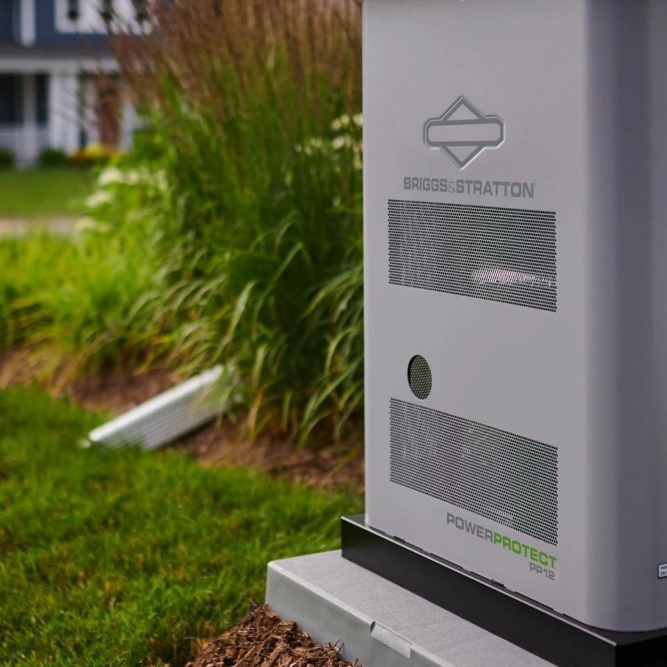 Outdoor gray utility cabinet with mesh vents beside grass and plants