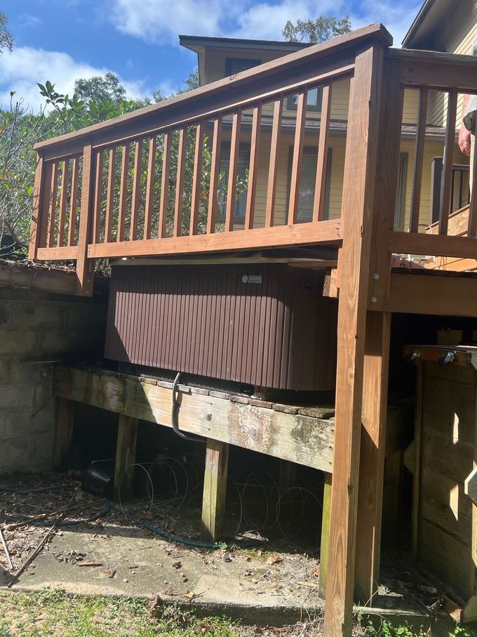 Blue dumpster filled with trash bags, tools, and a large, woven basket, outdoors near trees. Blue dumpster filled with trash bags, tools, and a large, woven basket, outdoors near trees.