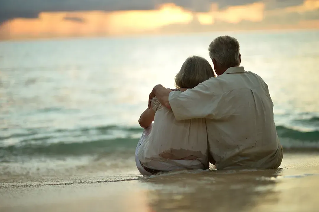 Elderly couple sitting on beach in Whittier, CA 