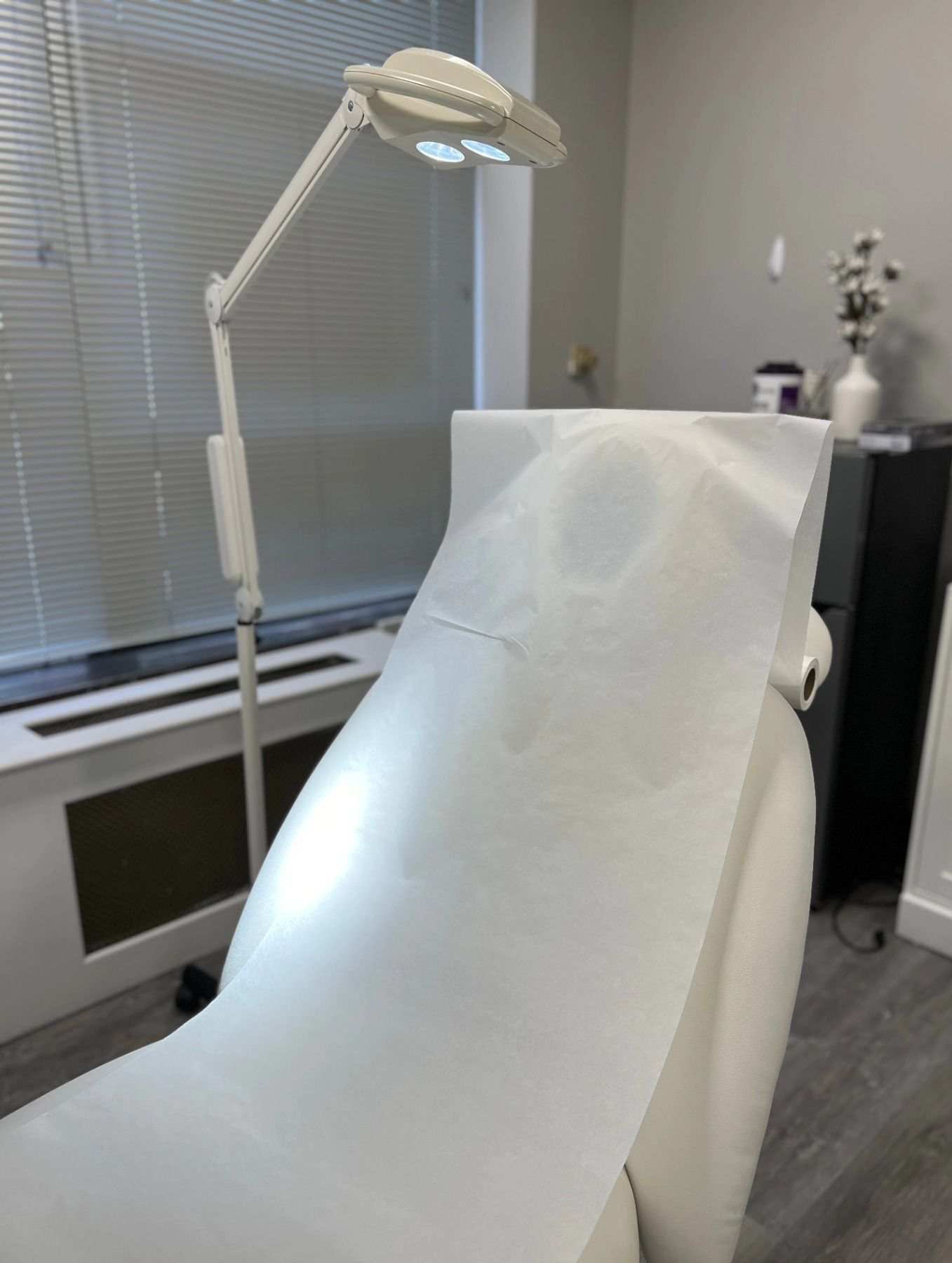 A white couch with a lamp on top of it in a room.