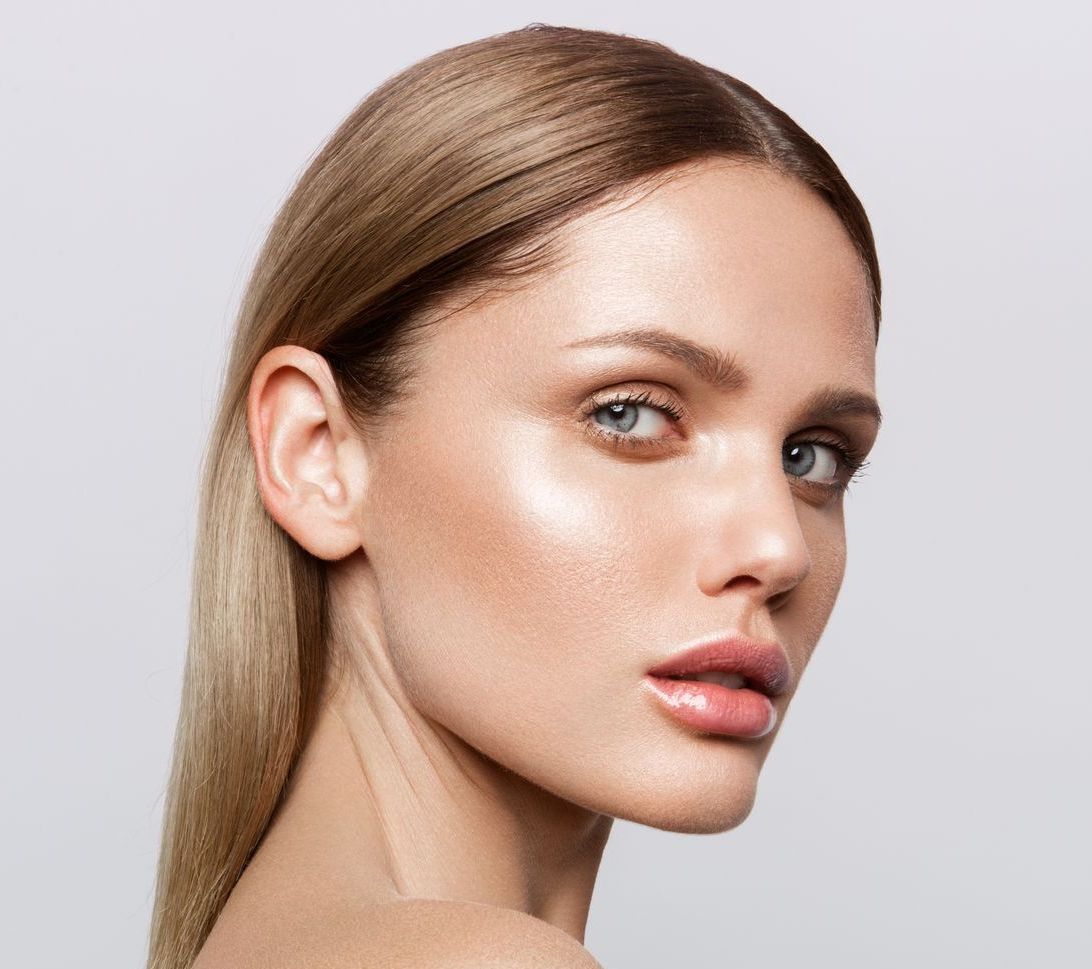 A woman is getting a botox injection in her face.