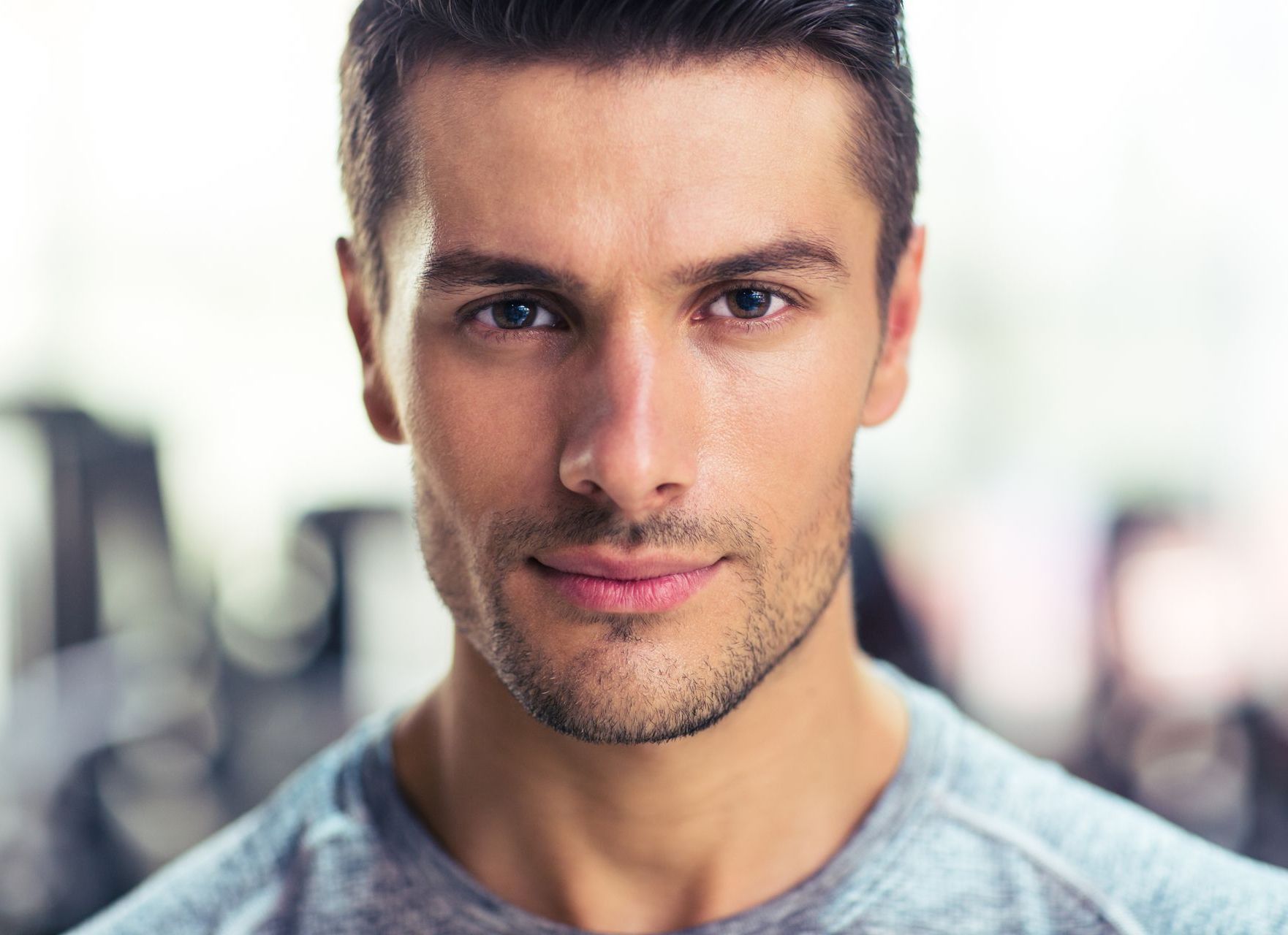A close up of a man 's face in a gym.