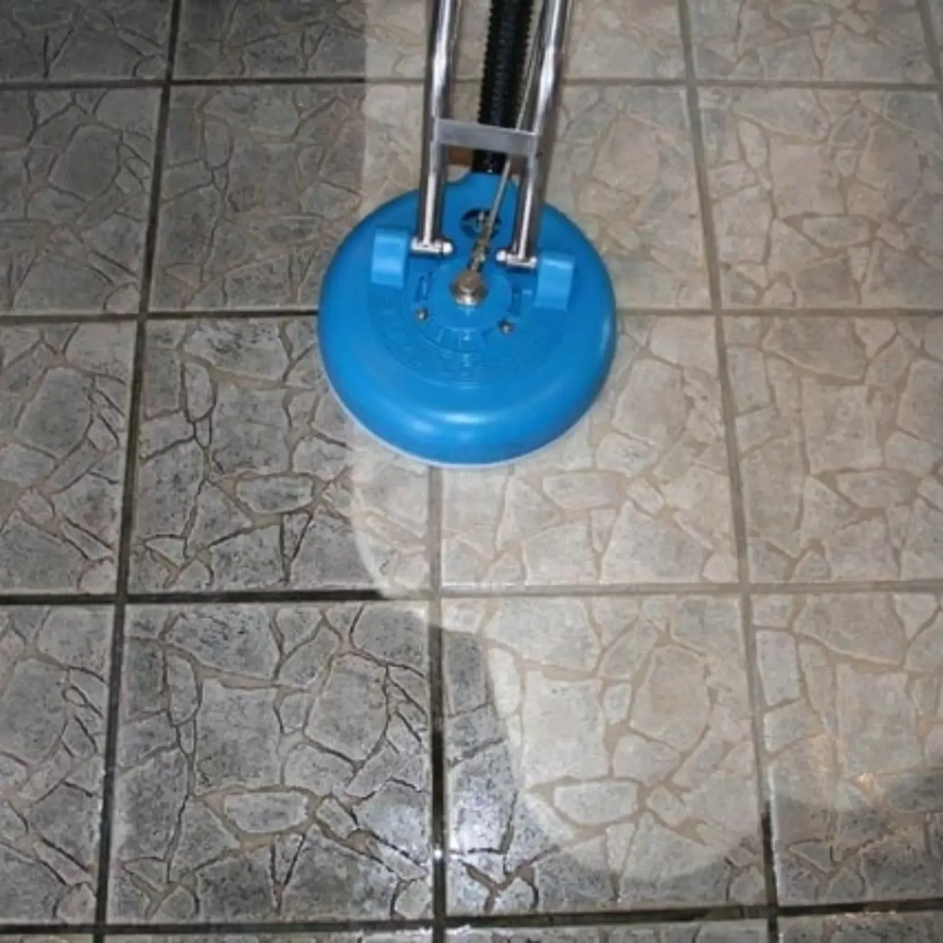 Powerhouse Carpet cleaning - A blue vacuum cleaner is cleaning a tiled floor