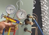Man holding manometer — Air Conditioning Contractors in Rushville, IN