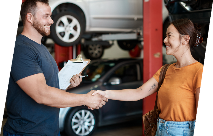 Mechanic shaking hands with a customer in a garage | Roper Mountain Auto Care