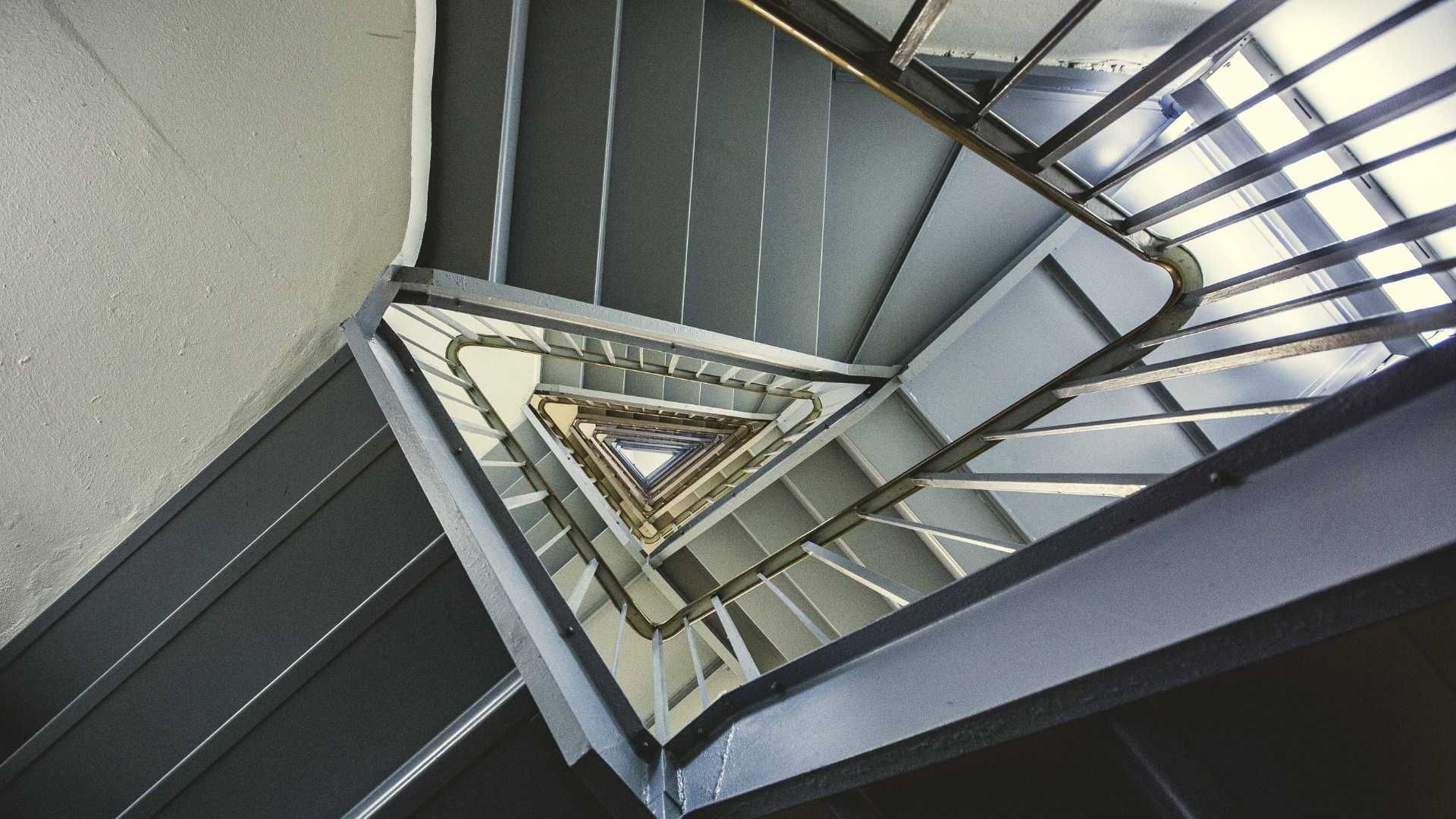 Looking up at a spiral staircase in a building