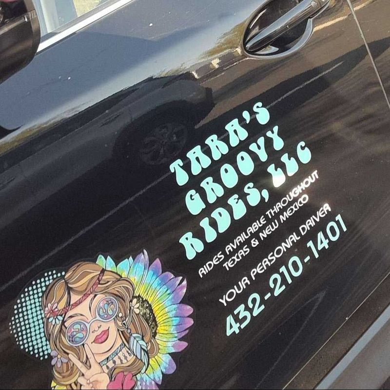 Black car door with a groovy rides logo featuring a woman and phone number.