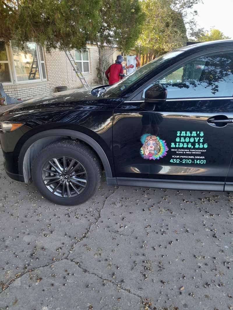 Black car with side decal advertising 