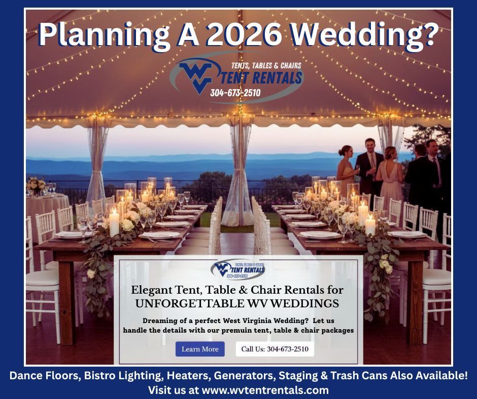 Tables and chairs set elegantly under a tent with floral centerpieces and scenic hills