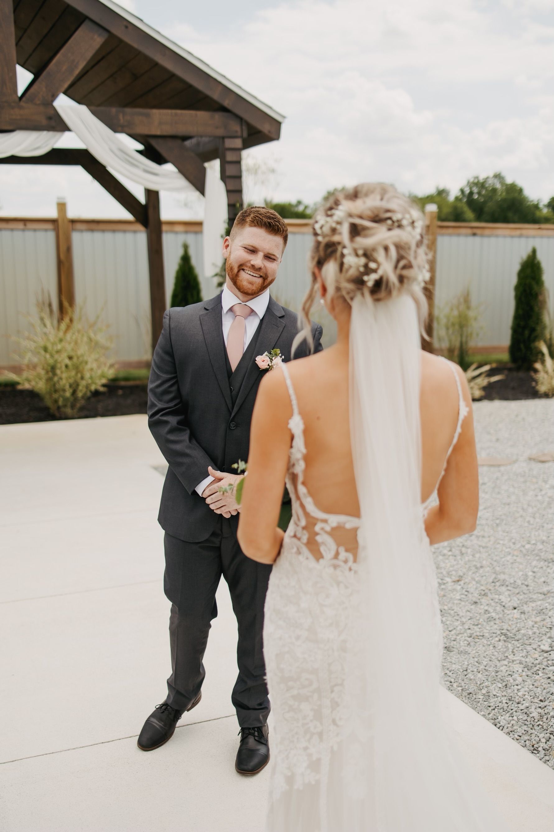 A bride and groom are standing next to each other on their wedding day.