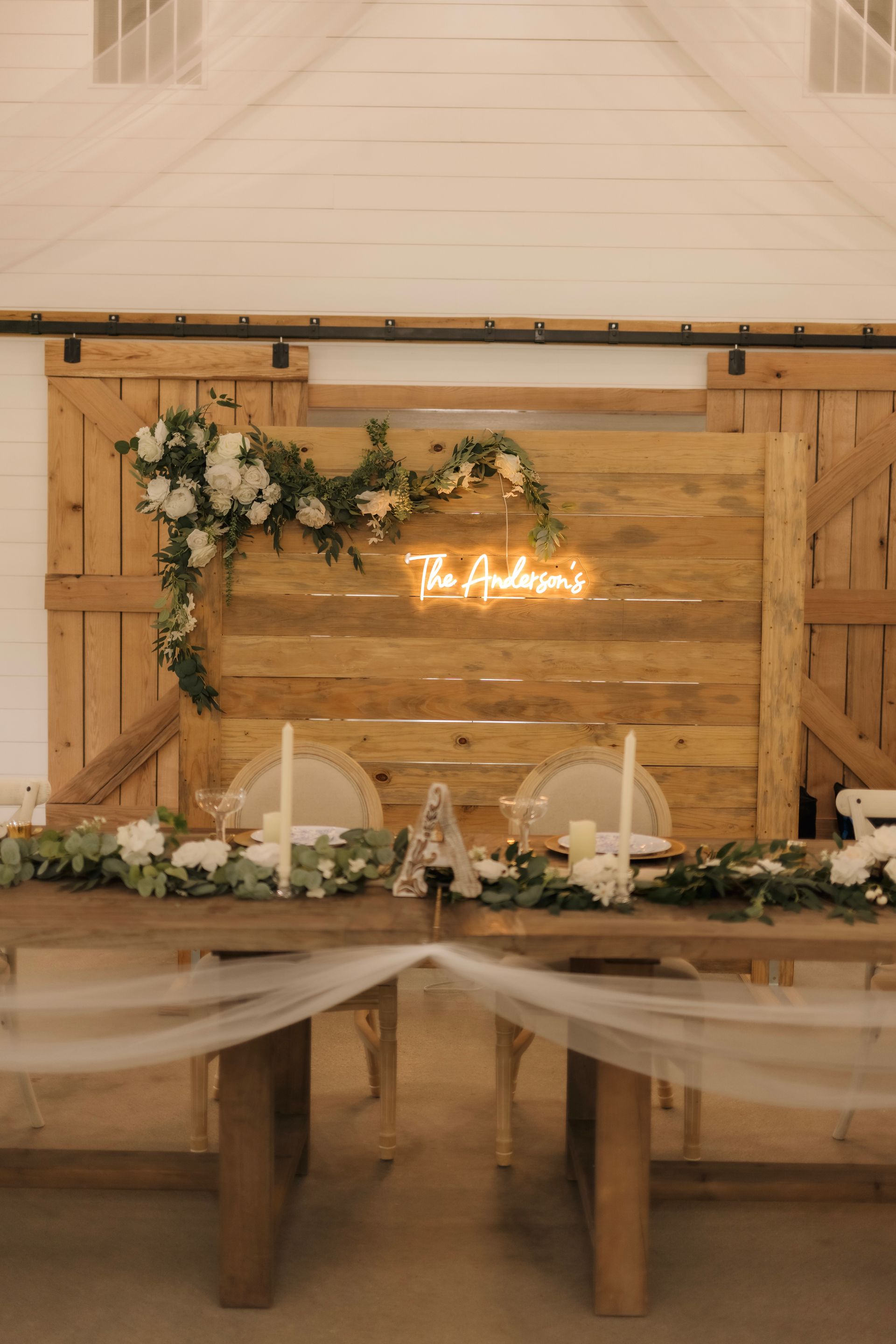 A wooden table with a neon sign that says `` the andrews '' on it.