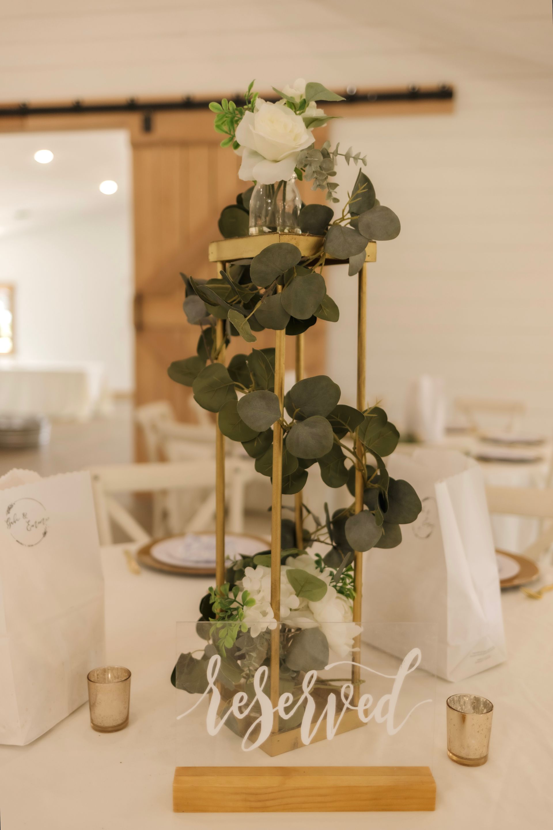 A table with a reserved sign and flowers on it.