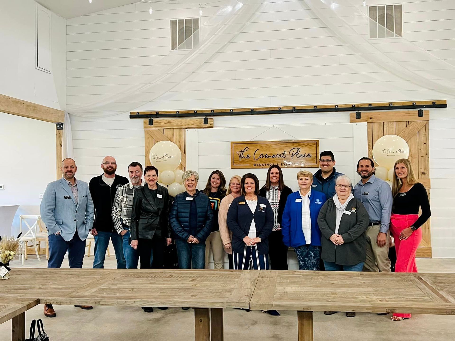 A group of people are posing for a picture in a room.