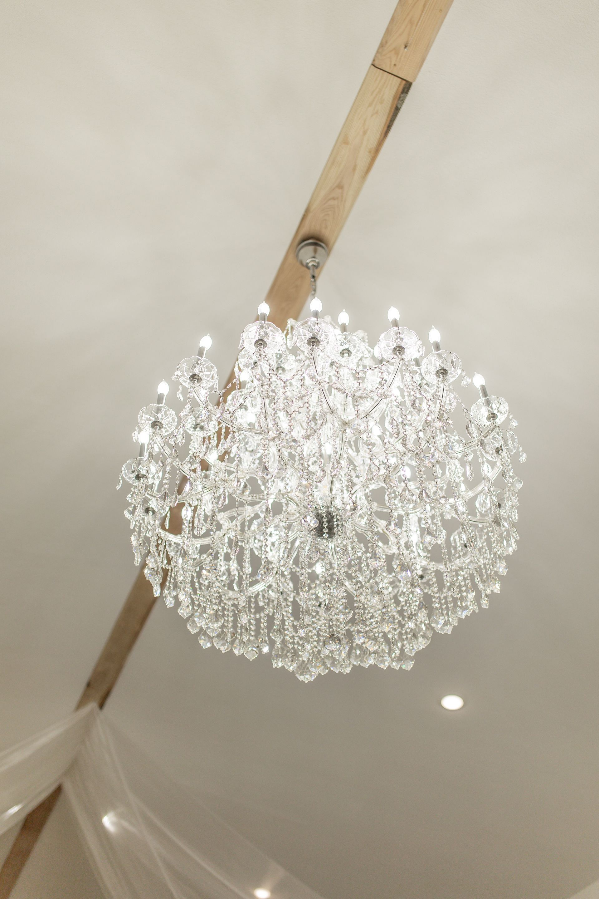 A large chandelier is hanging from the ceiling of a room.