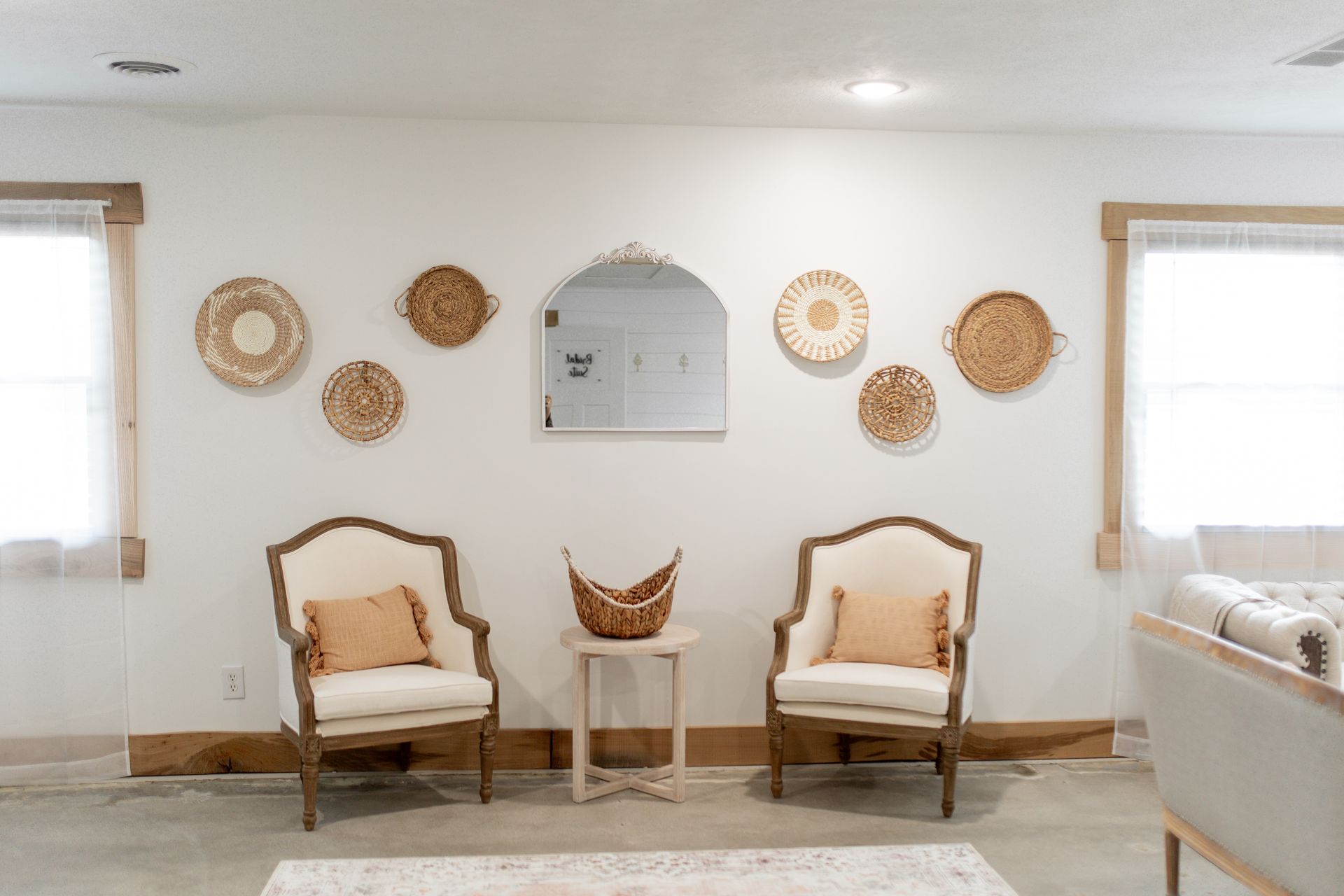 There are two chairs and a table in the living room.