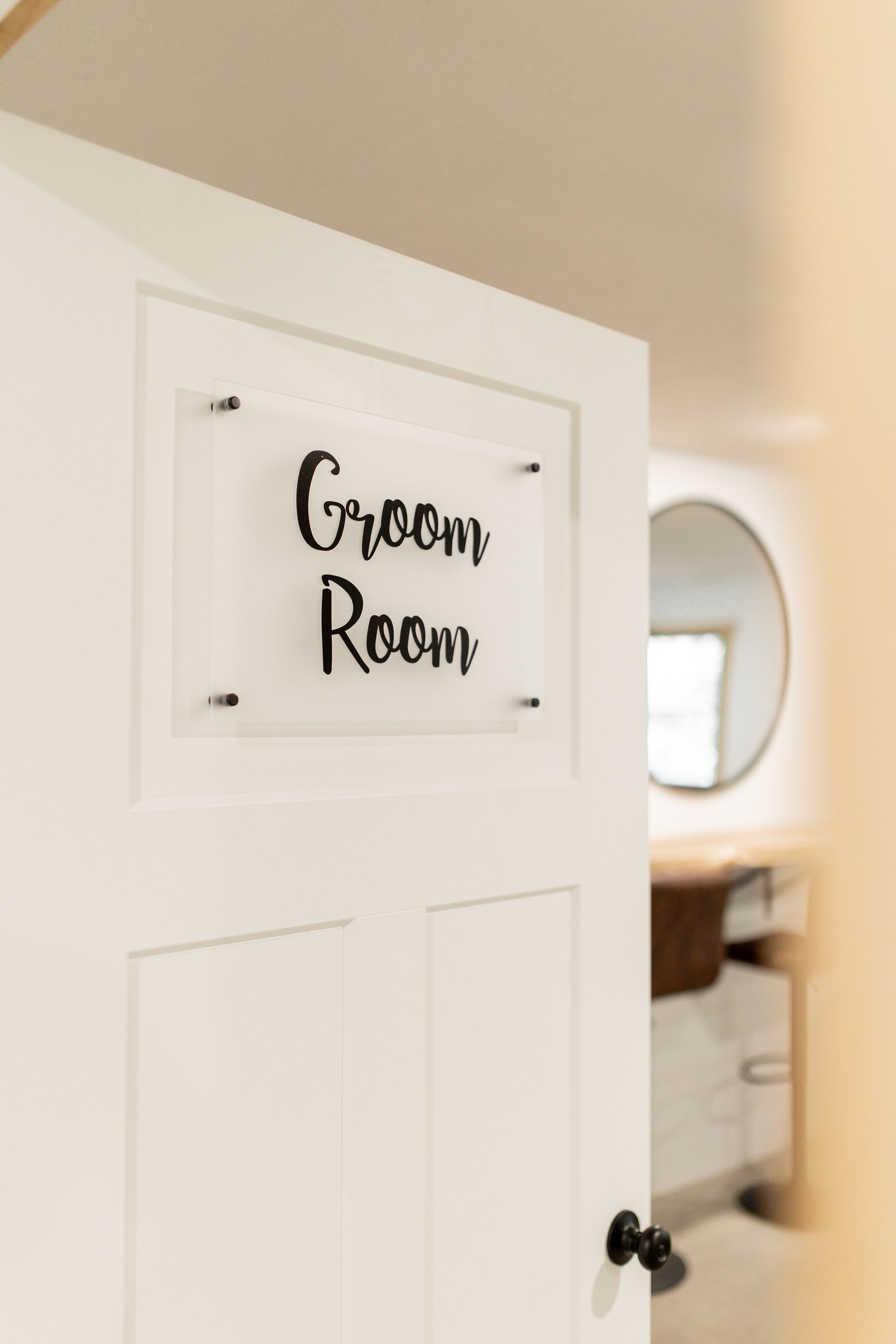 A white door with a sign on it that says groom room