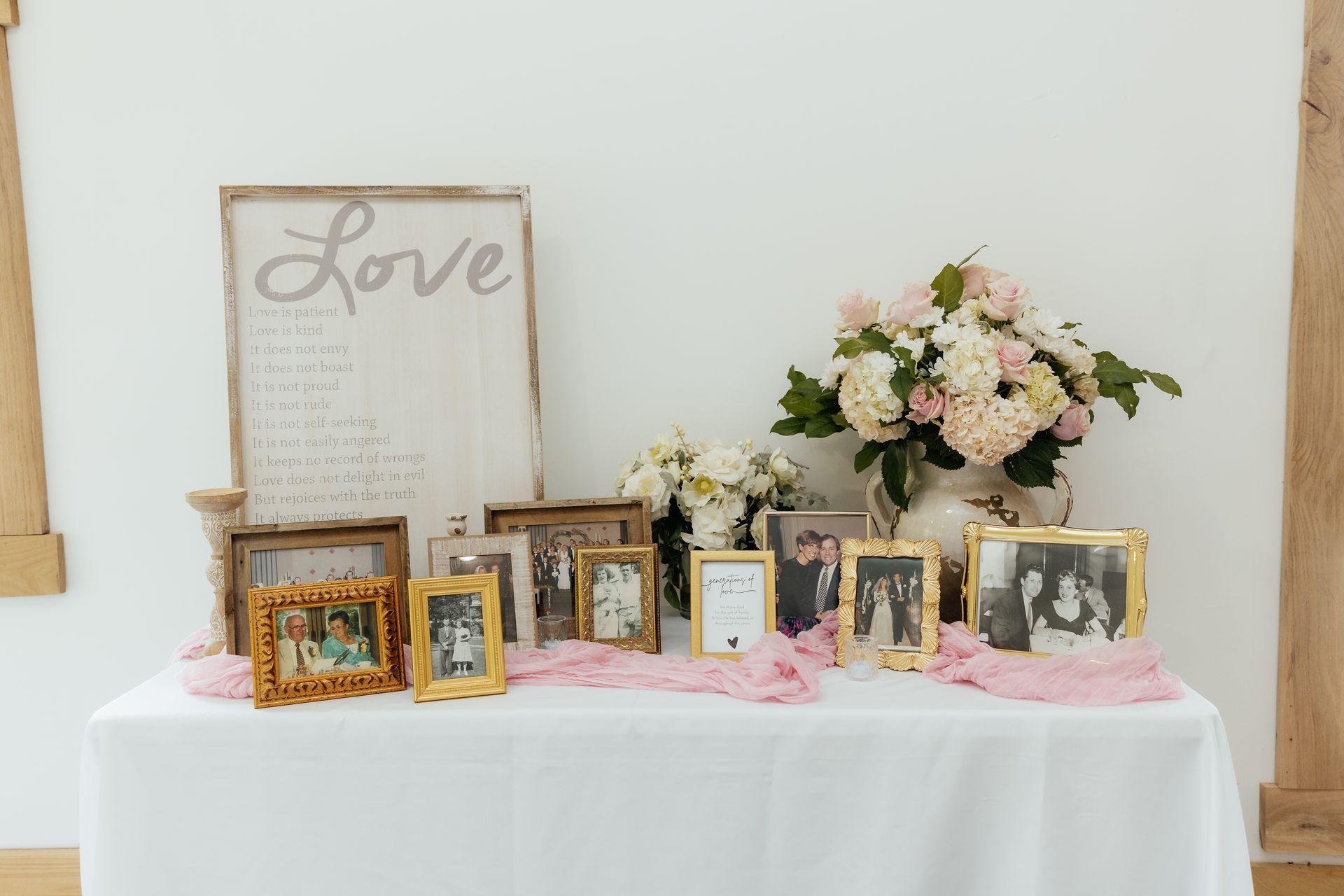 A table with a bunch of pictures on it and a sign that says `` love ''.