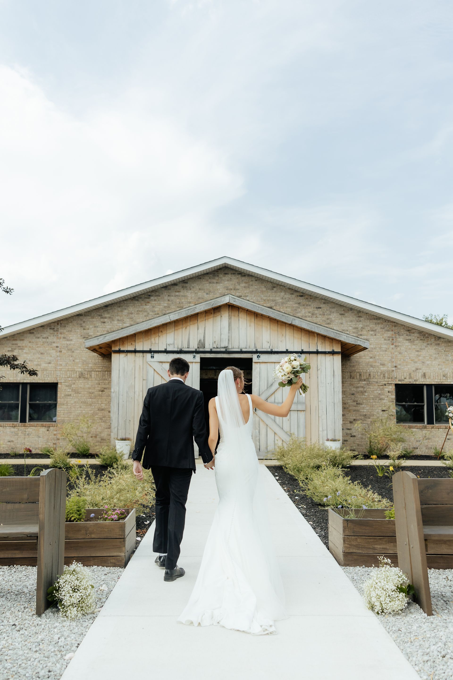 A bride and groom are walking down the aisle at their wedding.