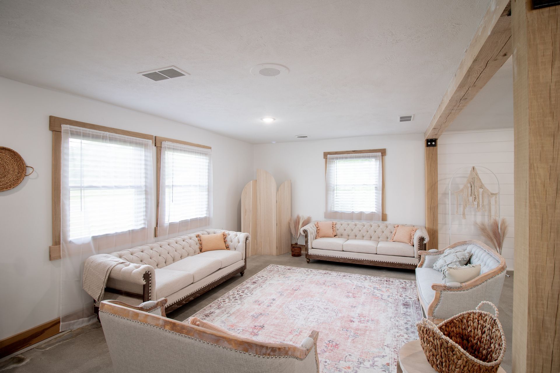 A living room with two couches and a rug.