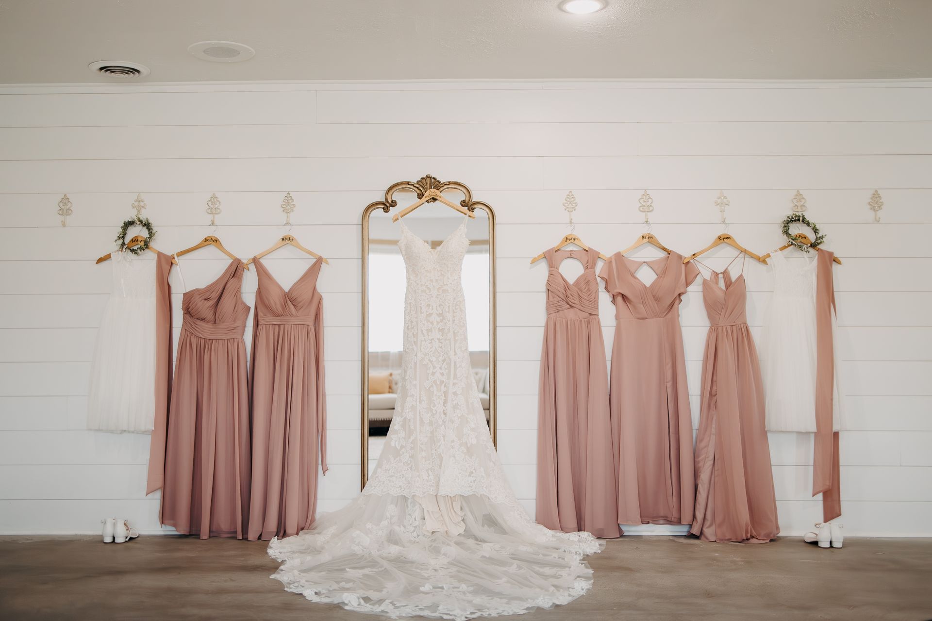 A bride and her bridesmaids are getting ready for their wedding in front of a mirror.