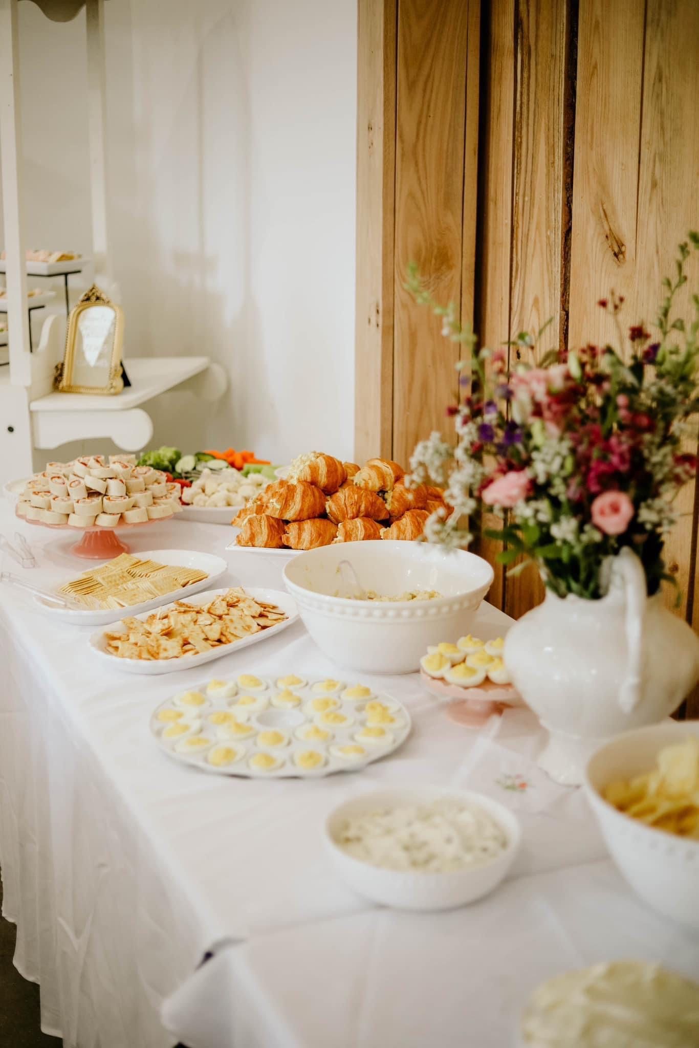 A table topped with plates of food and bowls of food.
