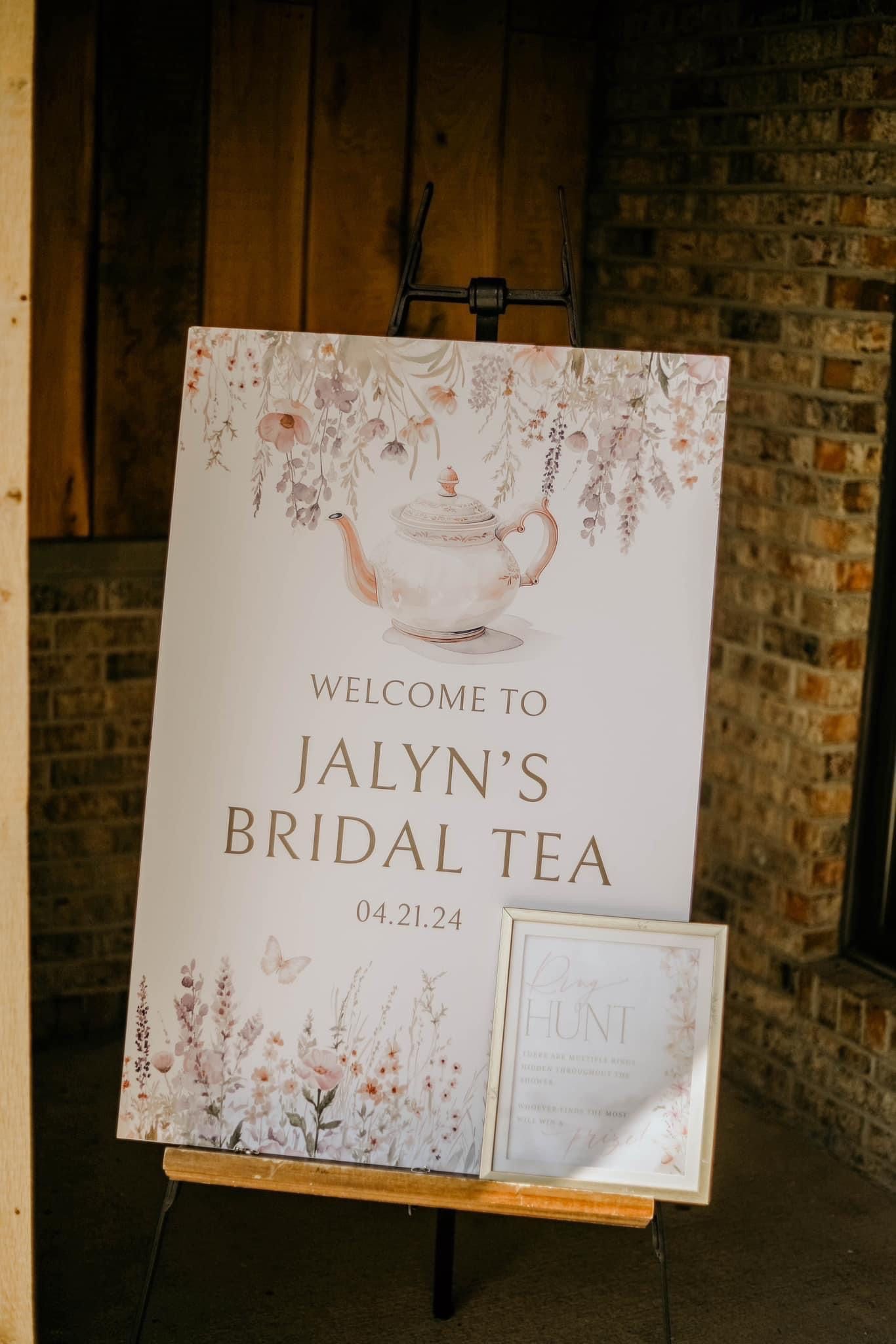 A sign for a bridal tea is sitting on a wooden easel.