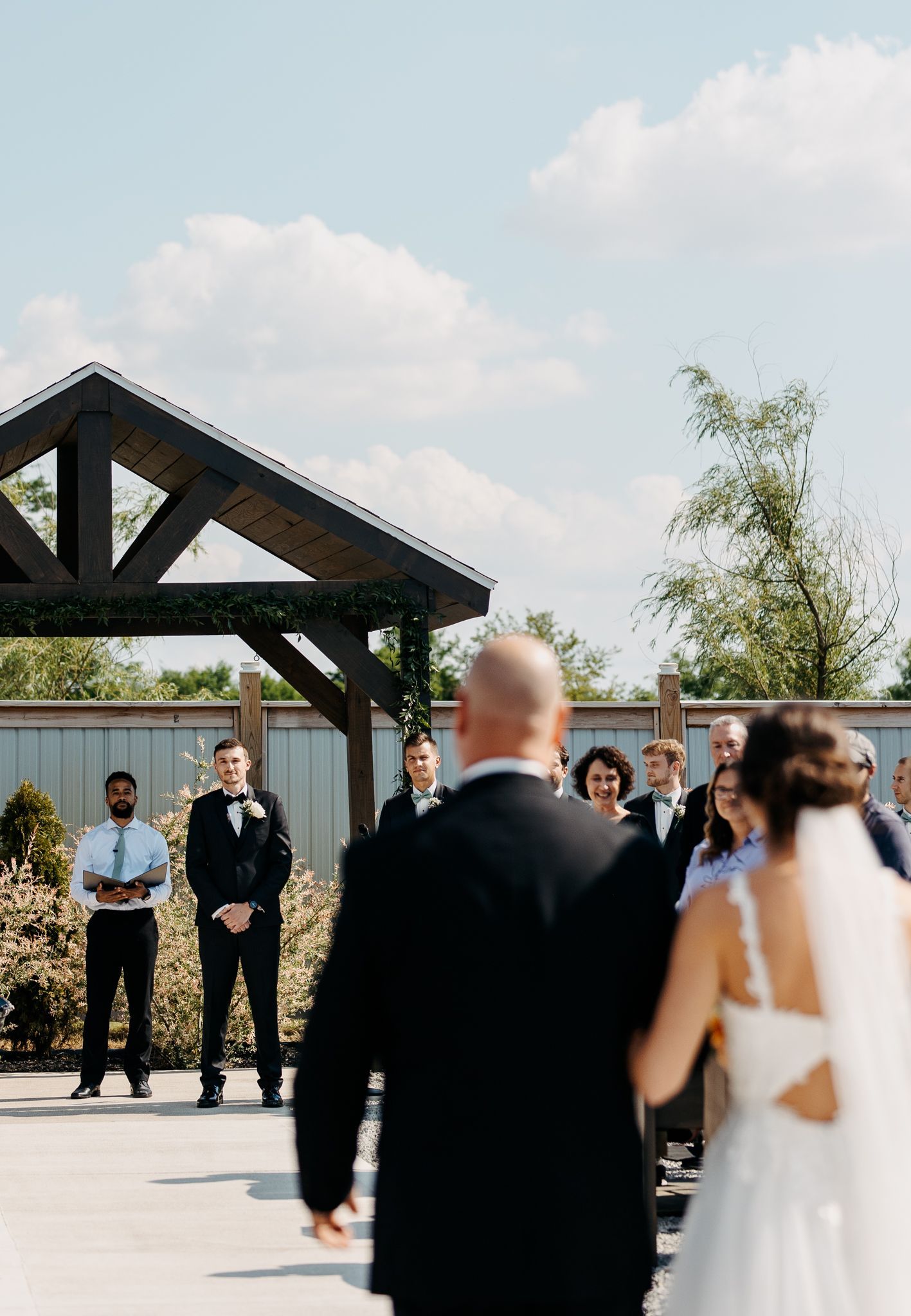 A bride and groom are walking down the aisle at their wedding ceremony.
