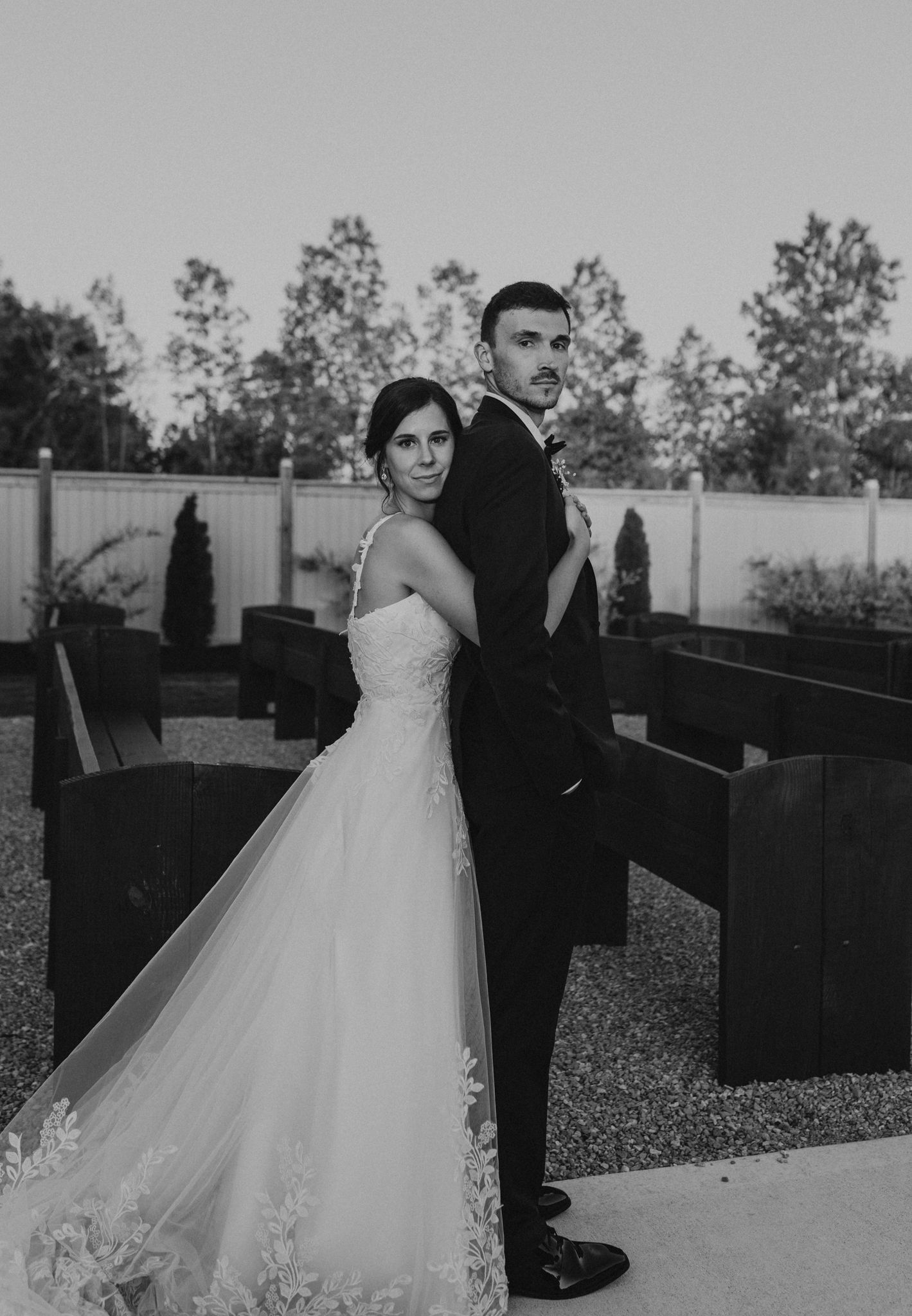 A black and white photo of a bride and groom posing for a picture.