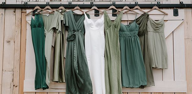 A bride and her bridesmaids are hanging on a rack.