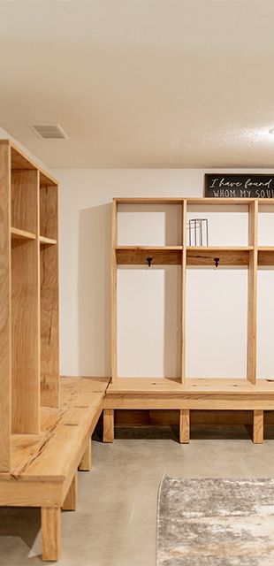 A locker room with wooden shelves and benches.