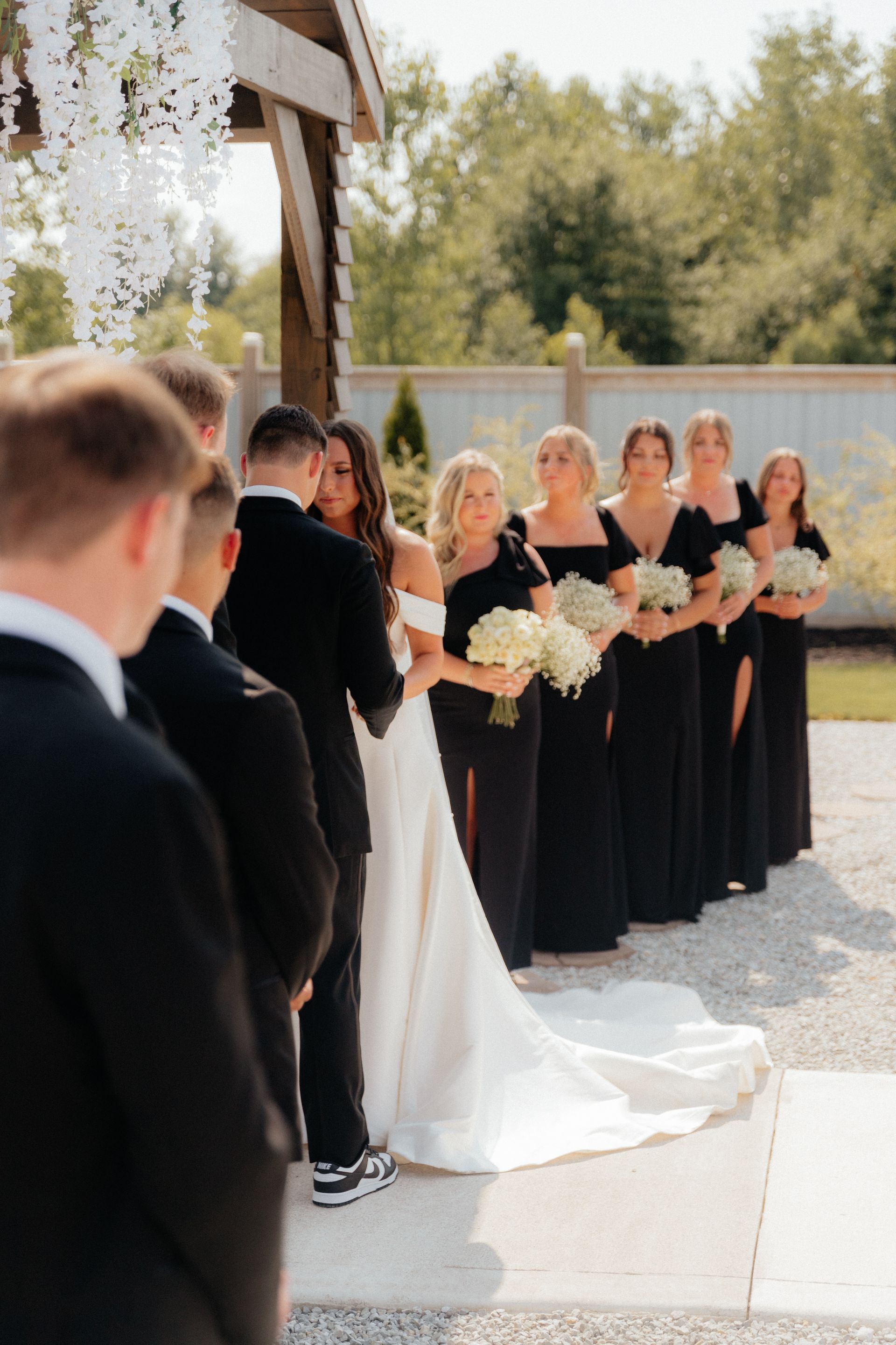A bride and groom are standing at the altar with their wedding party.