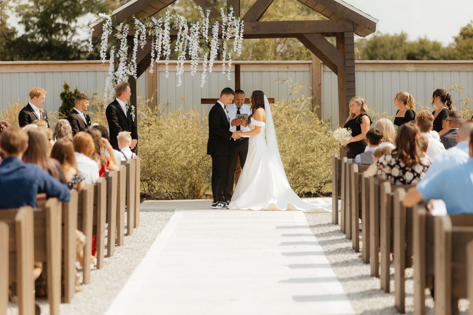 A bride and groom are getting married in front of a crowd of people in a church.