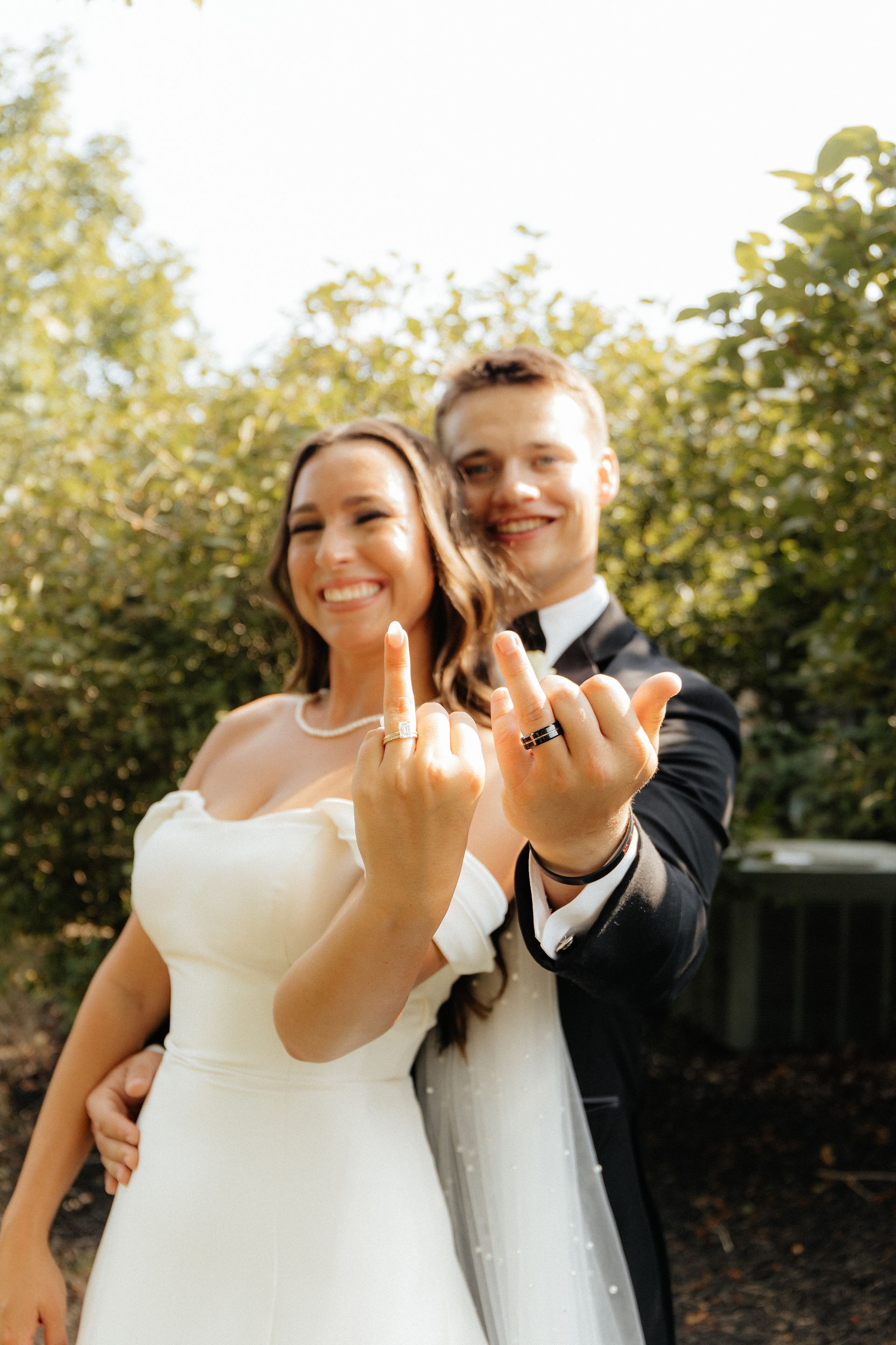 A couple showing their wedding rings.