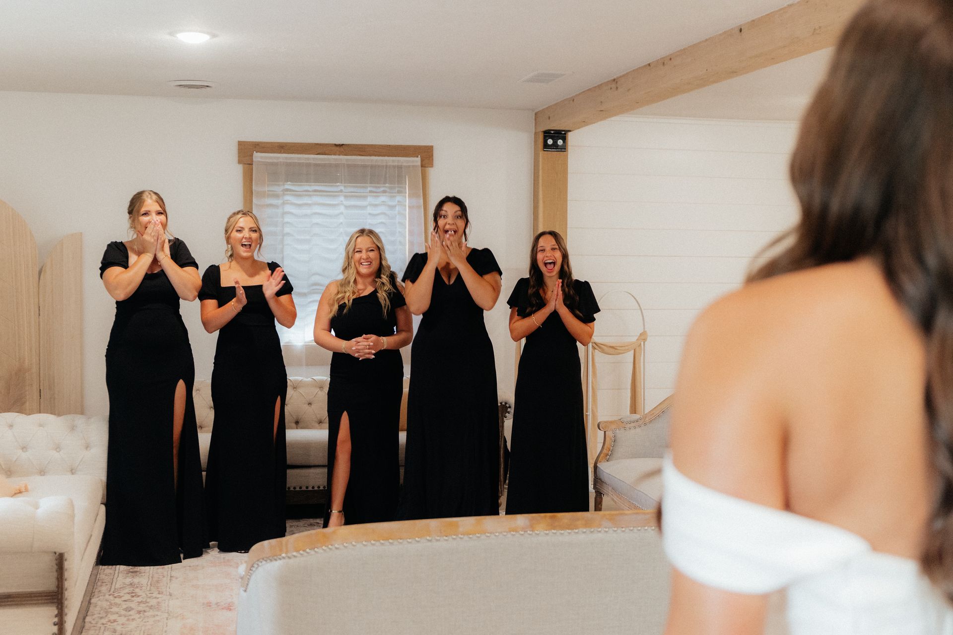 A bride and her bridesmaids are standing in a room.