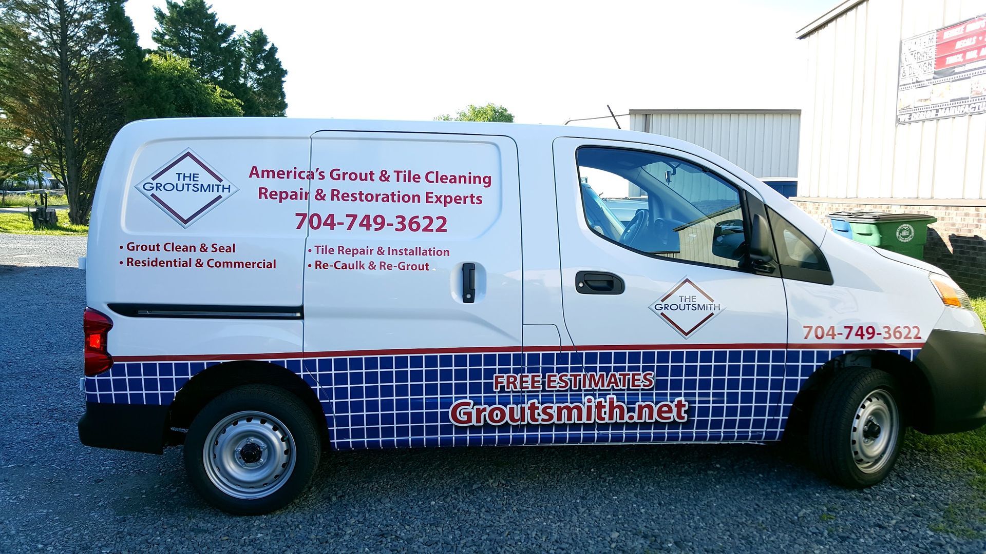 A white van with a blue and red checkered stripe on the side