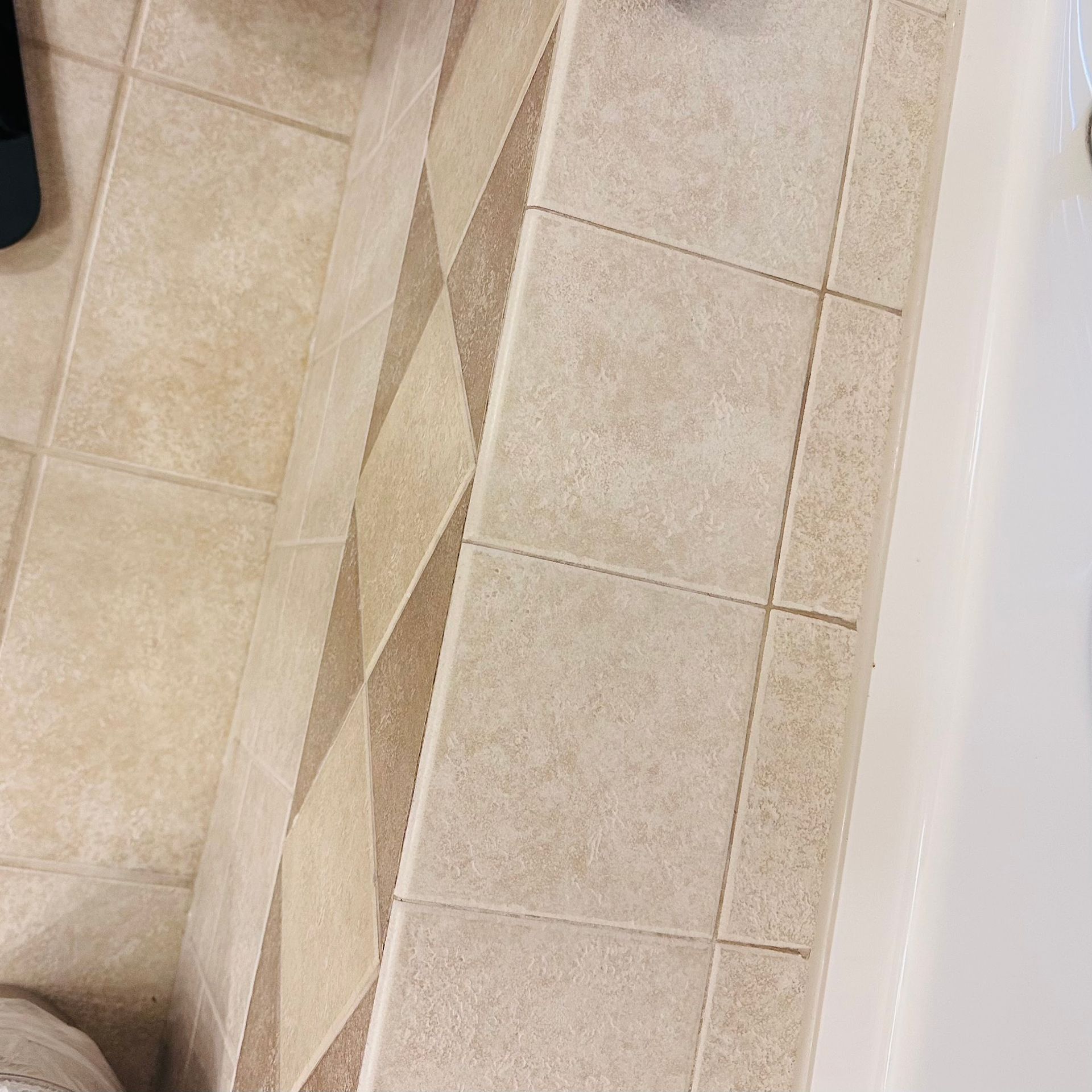 A close up of a tiled floor in a bathroom